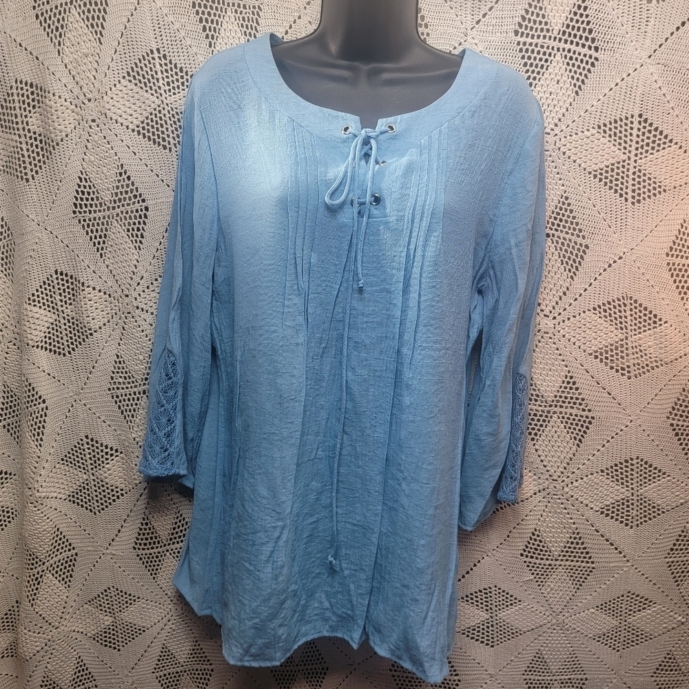 Hannah size large blue blouse with string tie front and lace in sleeves.